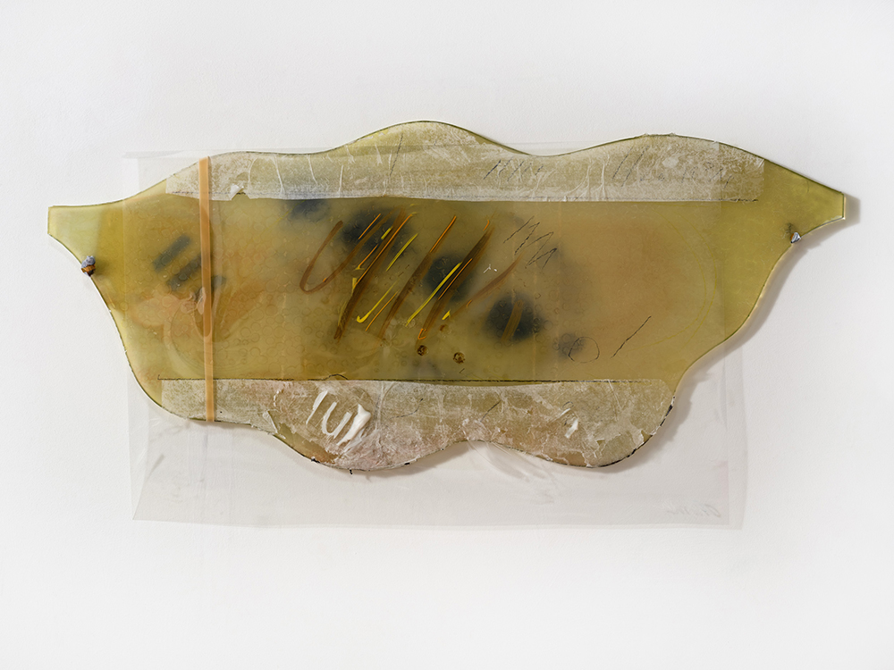 *Also Bathroom Mirror Piece*, 2024; burnt bathroom mirror, paper, paint, plastic, lead, rubber band; 17 x 32 x 1". Photography by Brica Wilcox. 