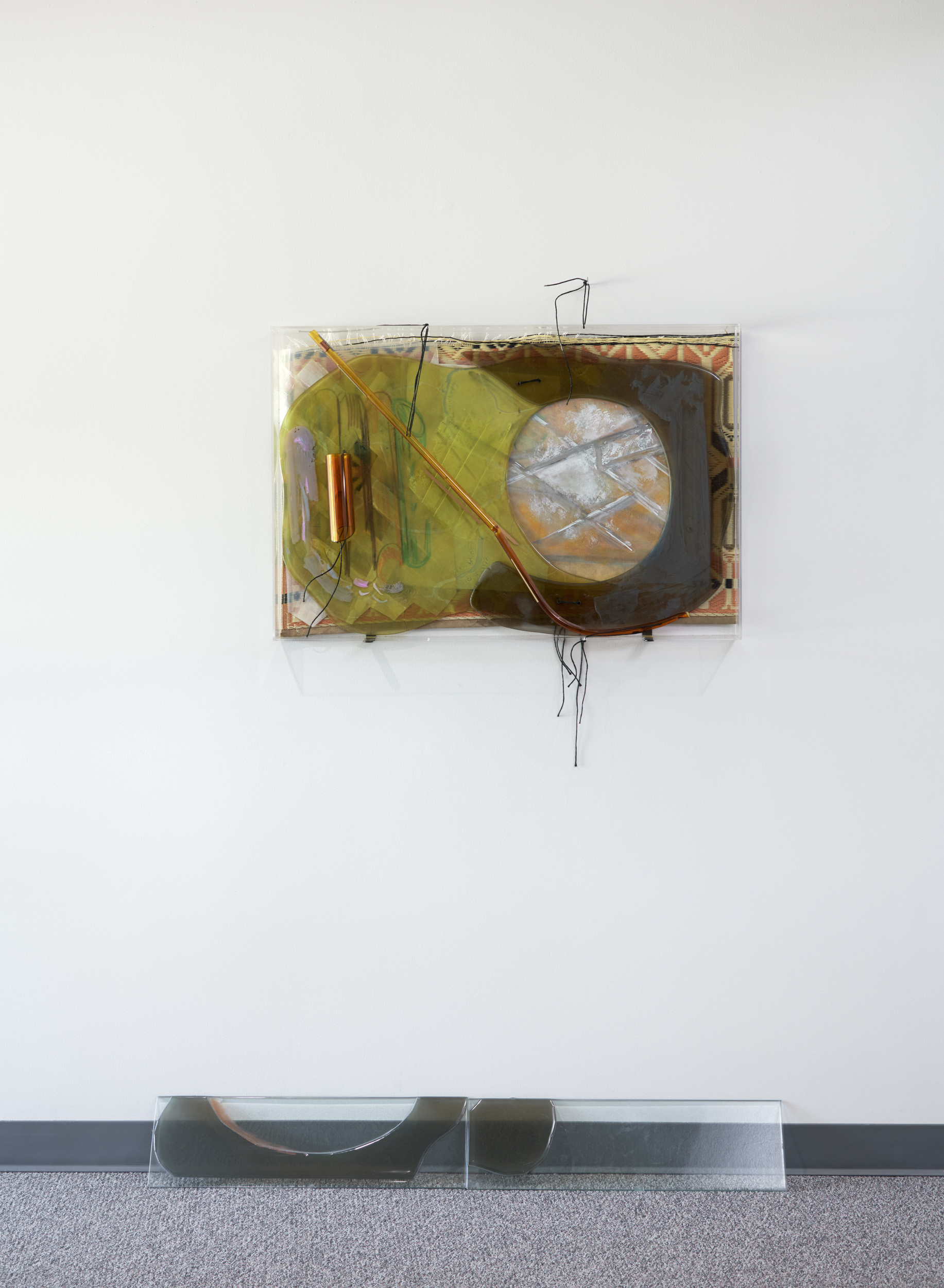 Tongue Thruster Piece, 2020-2022; Chalk on paper, marker on rubber, plastic carpet, paint on plastic, melted, cut and manipulated mirror with paint, cord, borosilicate wand, borosilicate light fixture, plexiglass frame; 24x36x3½. Tongue Thruster Baseboard, 2021; Etched and polished flash glass; 7x40x4 inches. Photography by Brica Wilcox.